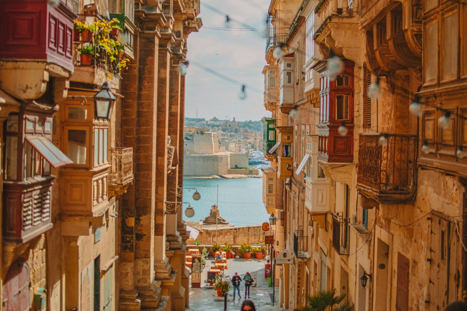 A narrow Valletta street with traditional wooden balconies